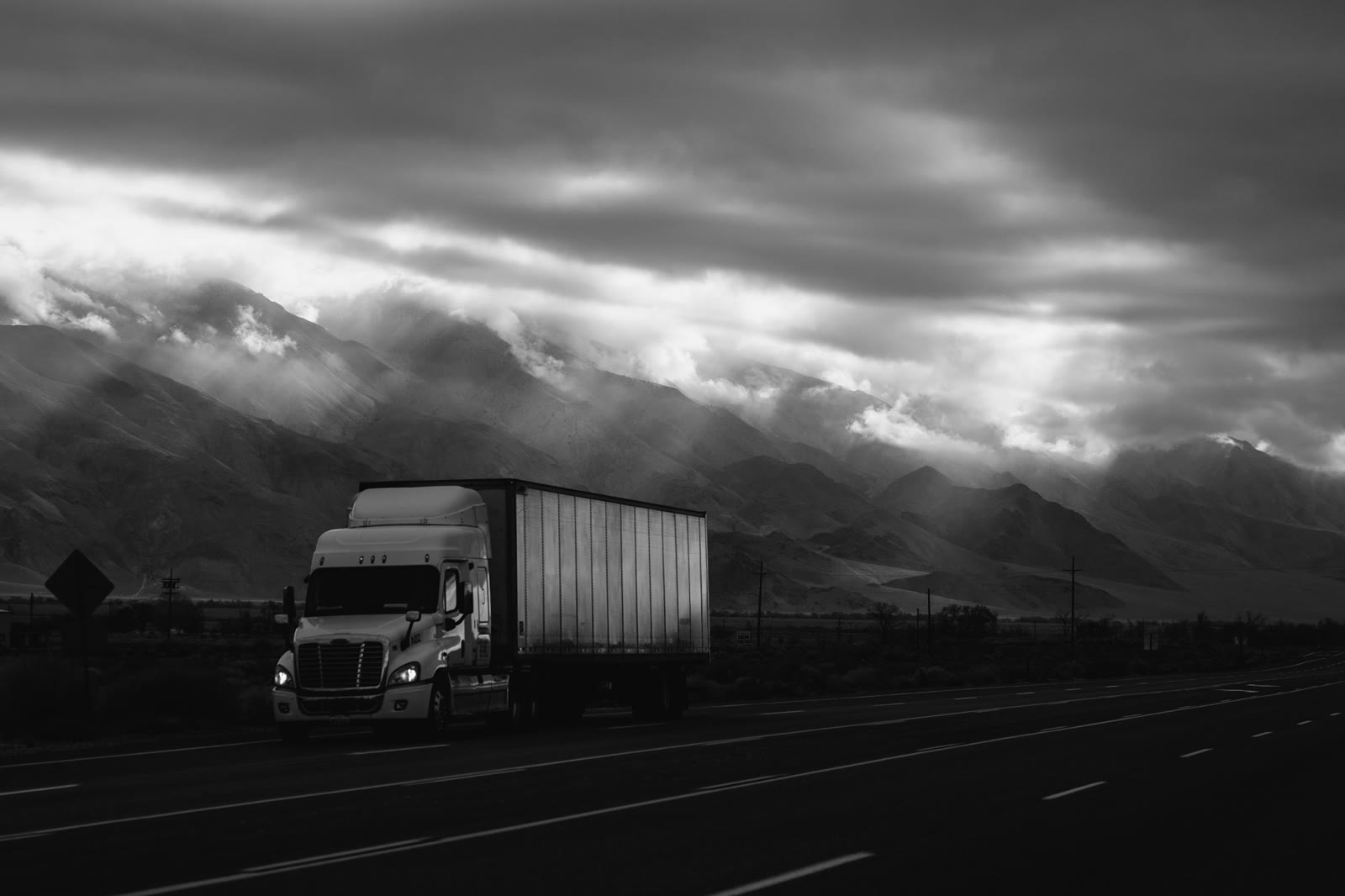 White tractor and box trailer on Highway 395 in Southern California